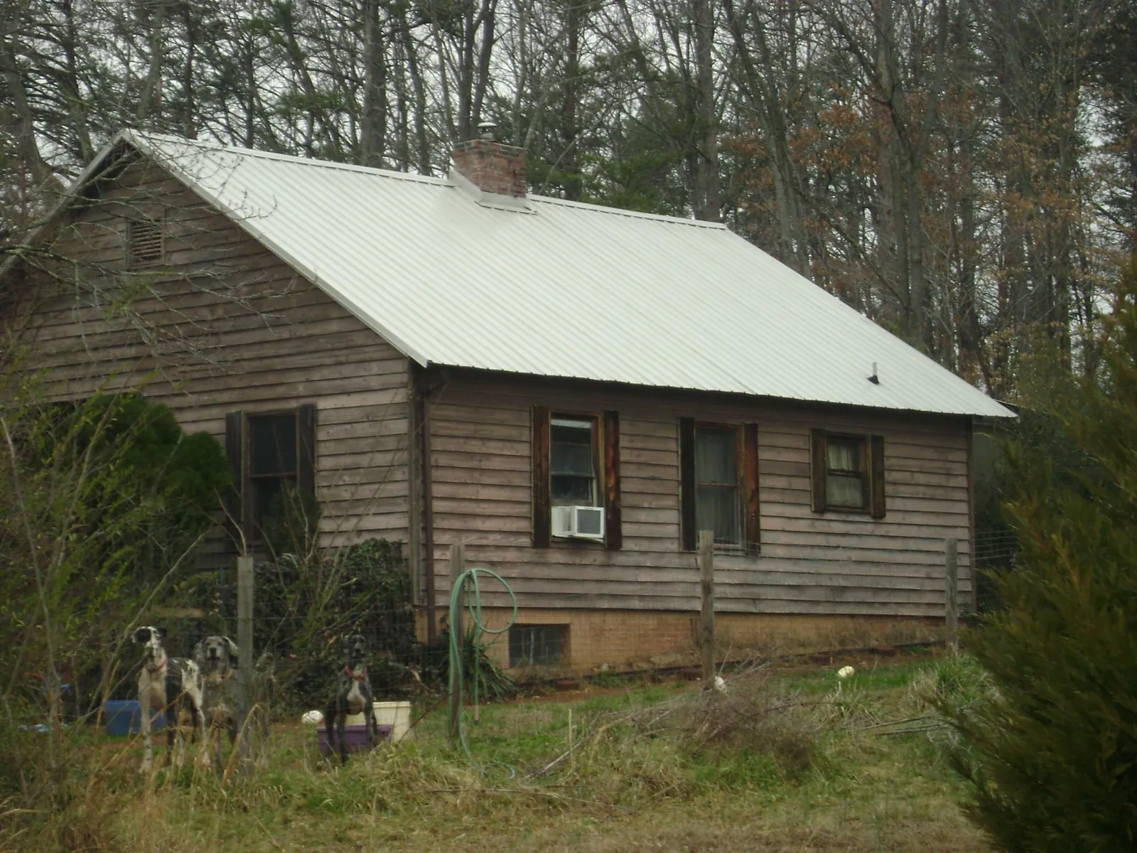 White metal roof on an old wood sided farmhouse, from a Metal Roof Installation job in Wynnewood